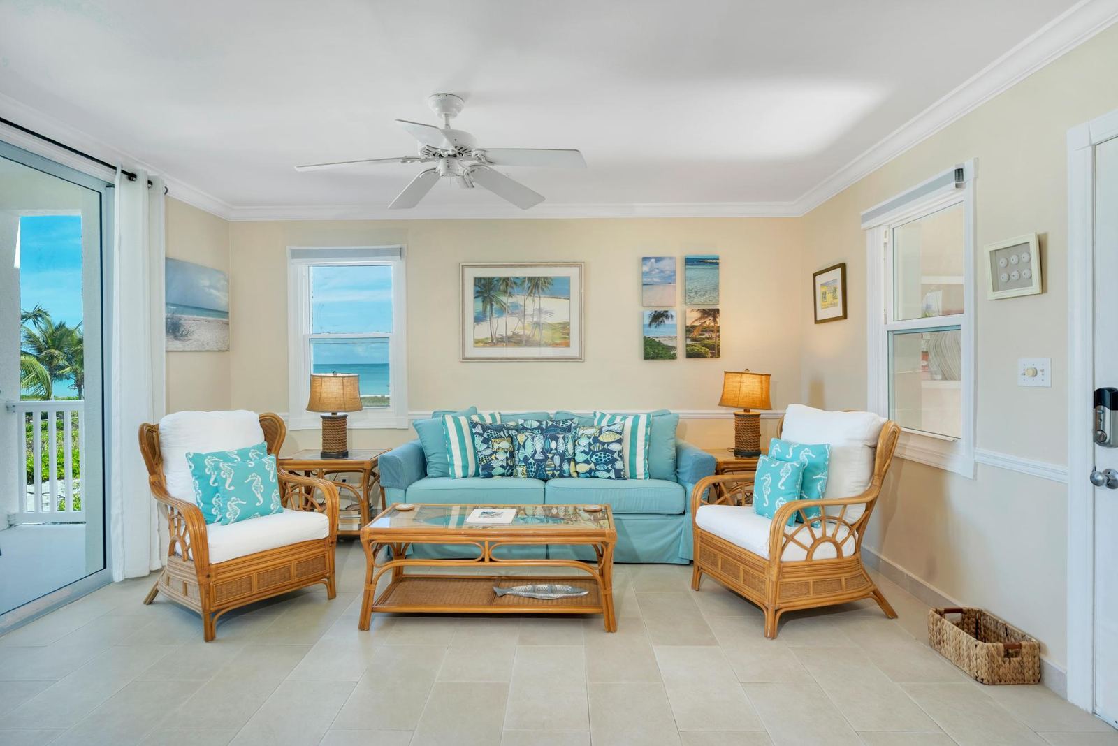 Open plan living area with balcony doors and ocean light