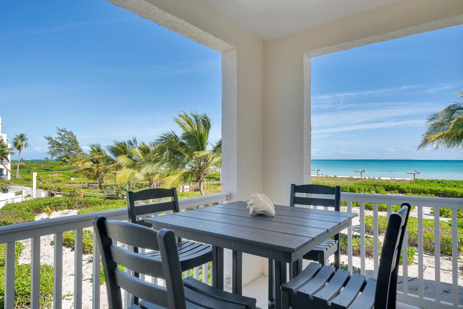 The covered ocean facing balcony at Residence B2-209, looking out over the dunes to the water