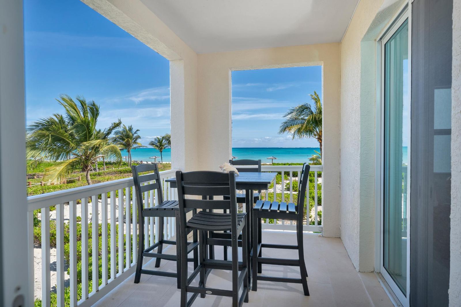 Covered balcony with bar height seating looking out to the ocean